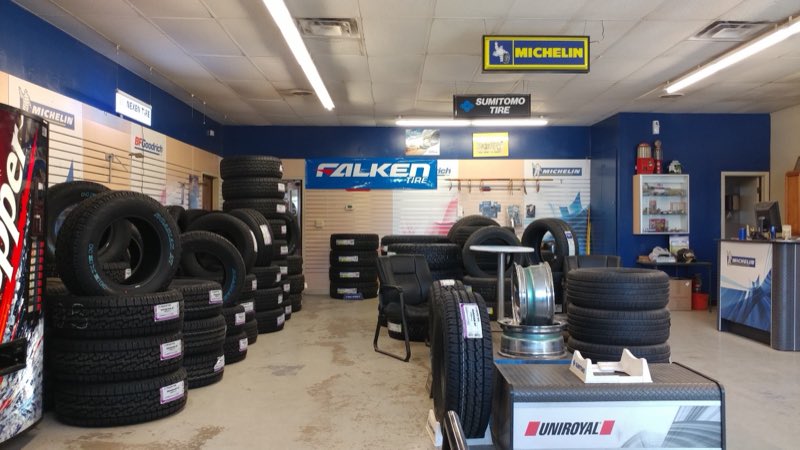 Bright showroom with racks and stacks of new tires